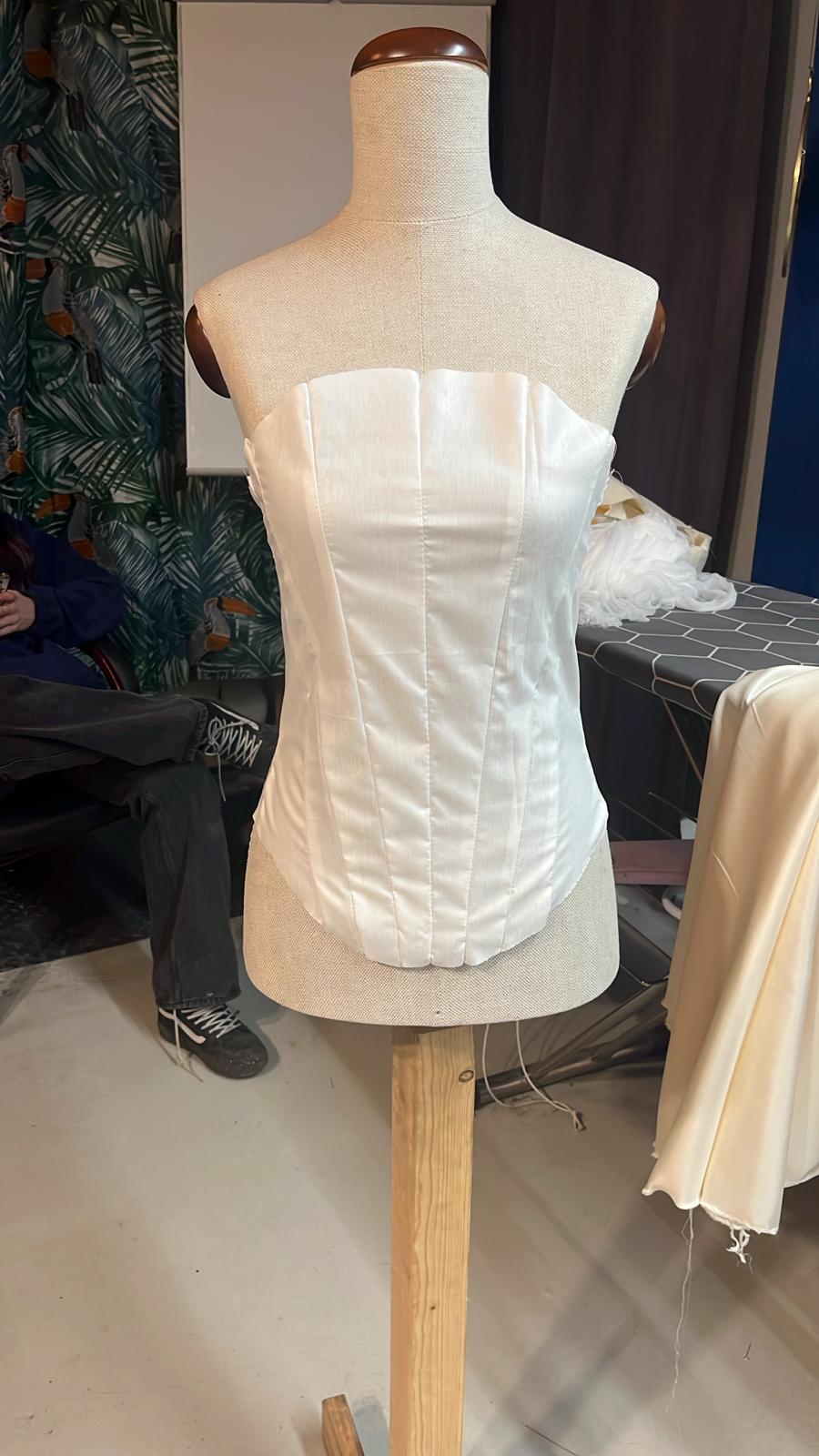 Custom-made bridal corset on mannequin showing perfect fit with complex construction